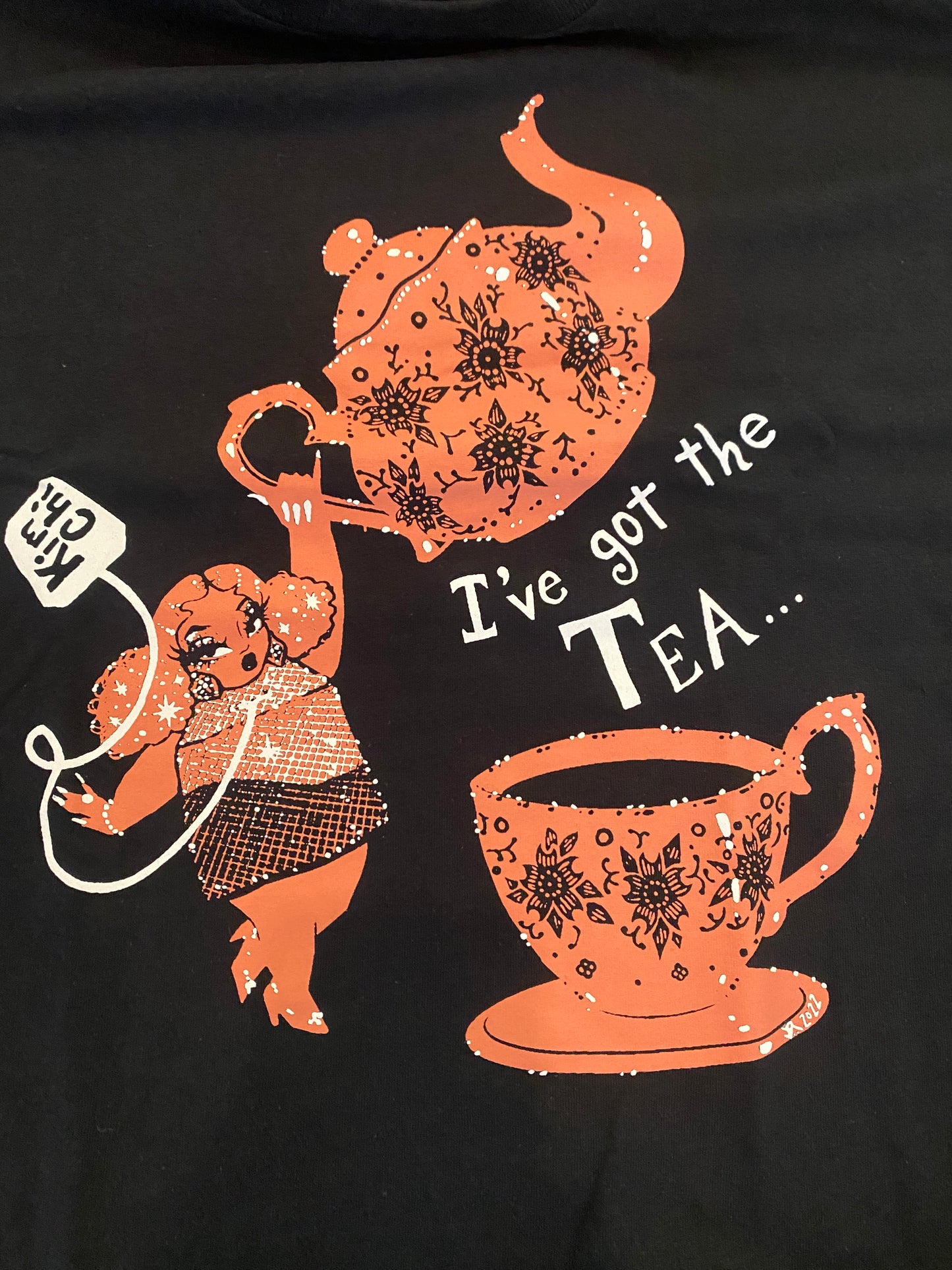 Kim Chi TeaCup Tee: black tee with orange "I've got the tea" teapot graphic